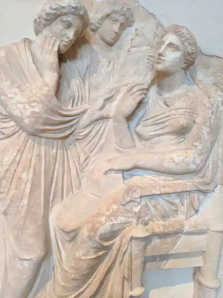 Pentelic marble grave relief of a seated woman, female servants, and her newborn child